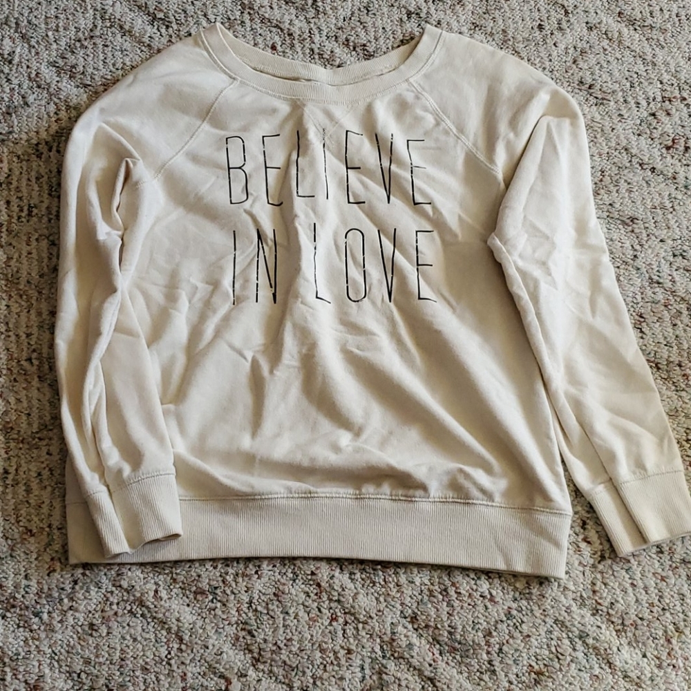 Crew neck says believe in love